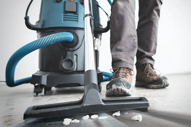 a person vacuuming the floor